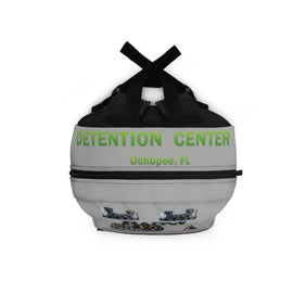 Gray spherical container with black straps labeled 'Detention Center Ochopee, FL' on a white background